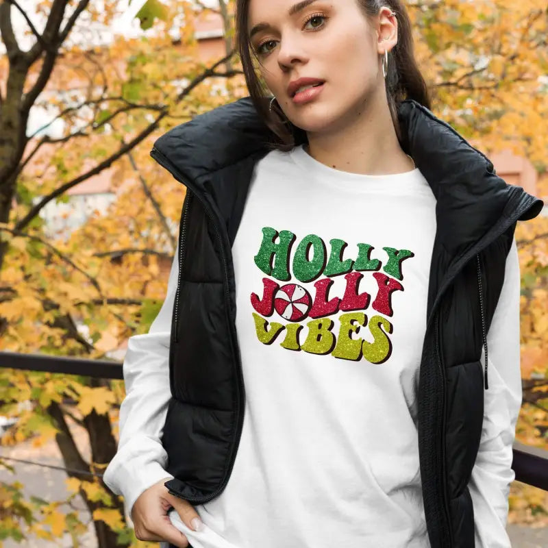 White sweatshirt with Holly Jolly Vibes in green, red, and yellow on cozy ring-spun cotton
