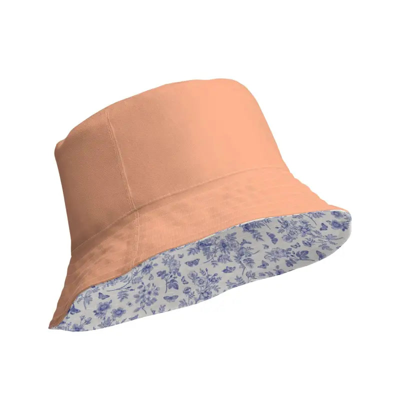 Peach reversible bucket hat with blue floral print lining for stylish summer vibes
