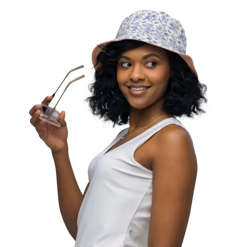Smiling woman in a white tank top and floral bucket hat flaunts the Solid Peach Reversible Bucket Hat