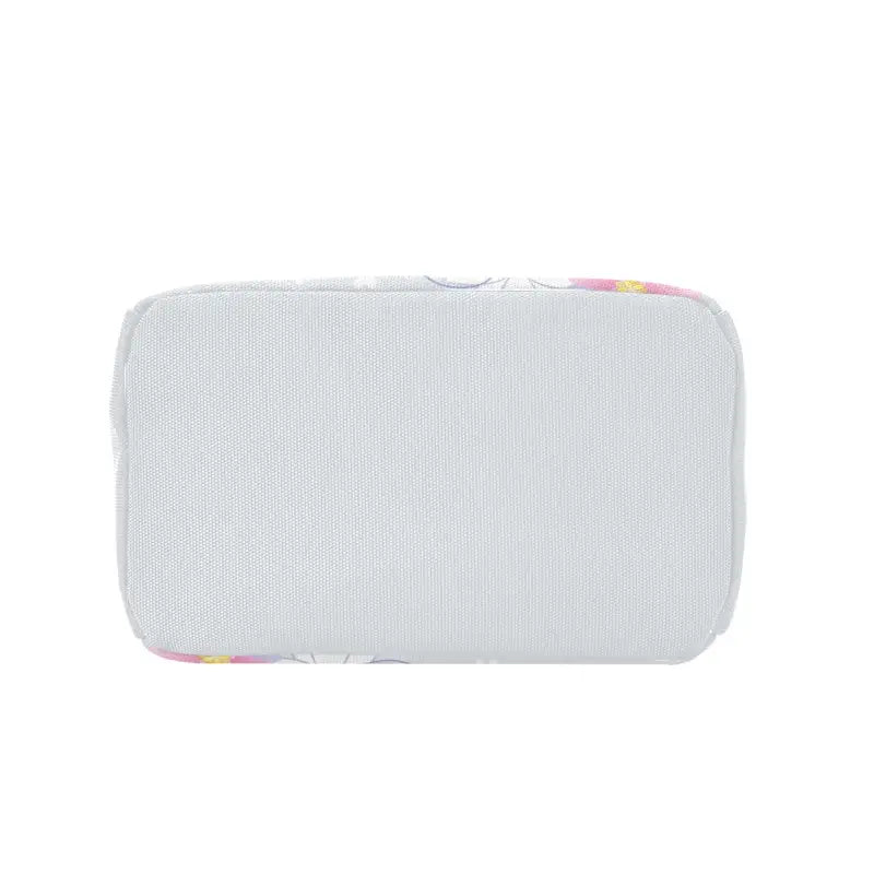 White speaker with rounded corners and colorful accents next to a floral insulated zipper lunch bag