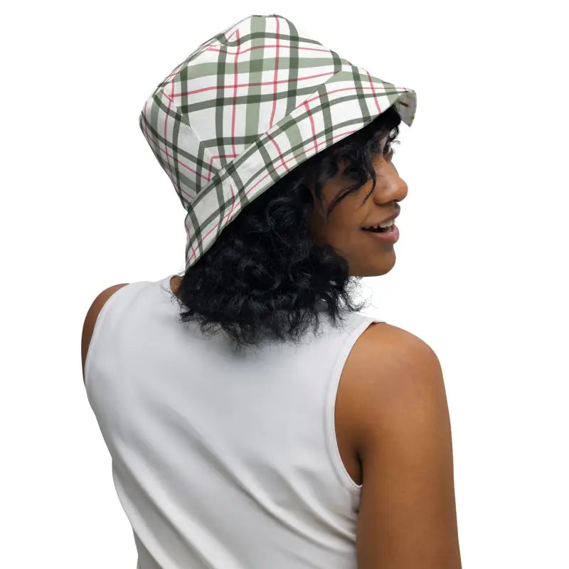 Plaid bucket hat on a person with curly dark hair, showcasing the Sunflower Reversible Bucket