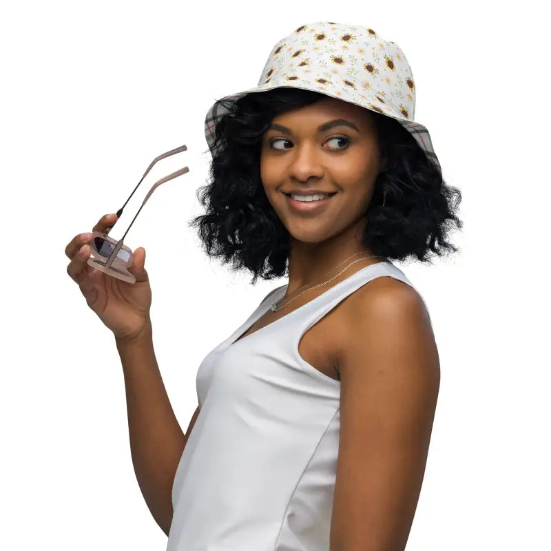 Smiling woman in a white tank top rocking a Sunflower Reversible Bucket Hat and sunglasses
