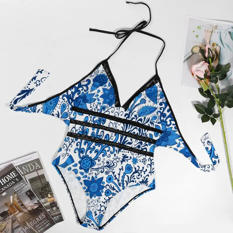 Blue and white floral patterned bikini piece swimsuit with black straps for summer fun