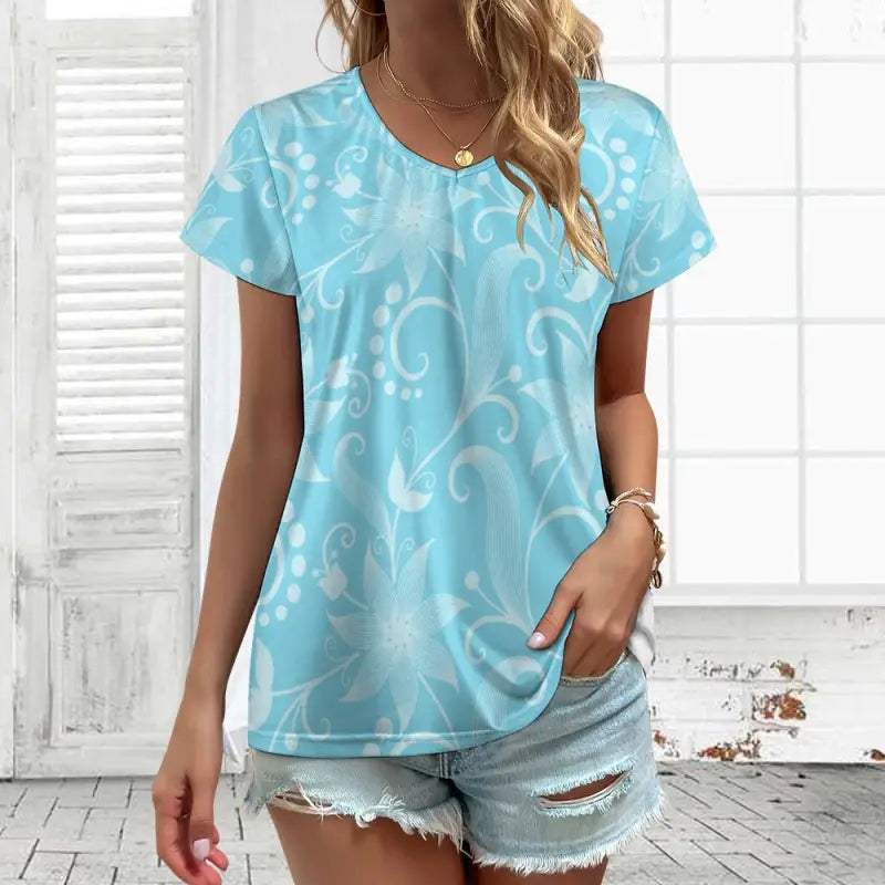 Light blue women’s floral v-neck t-shirt with a stylish white swirling pattern