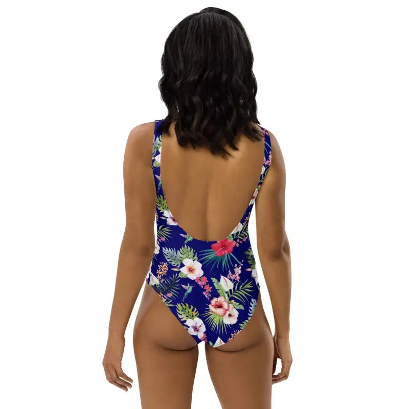 Dark-haired person rocking a Tropical Hawaiian One-Piece with a low back and floral design
