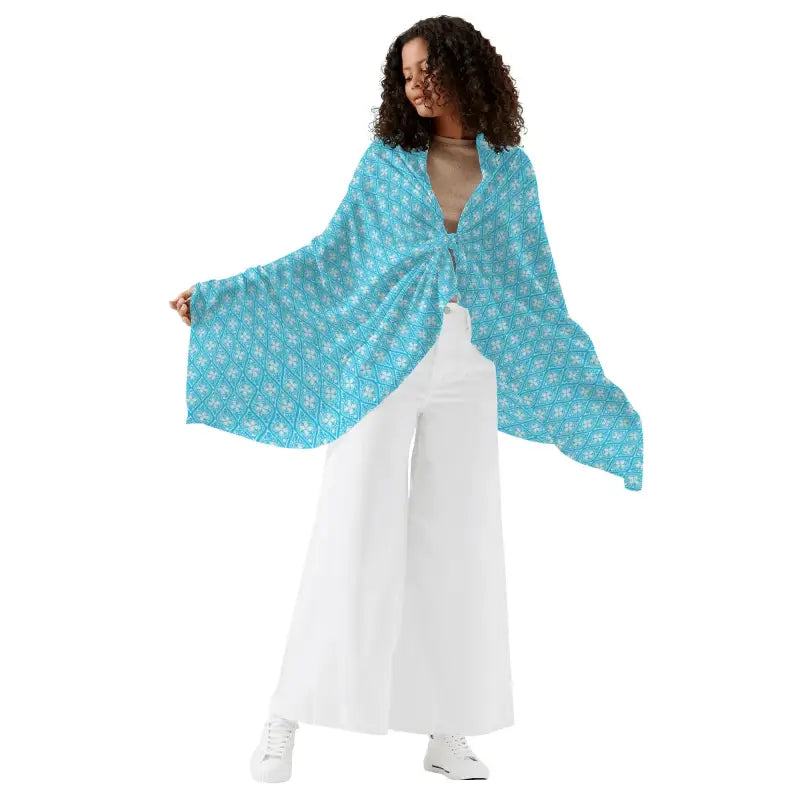 Turquoise shawl with floral design over a white dress, perfect for women’s sarong bikini fun
