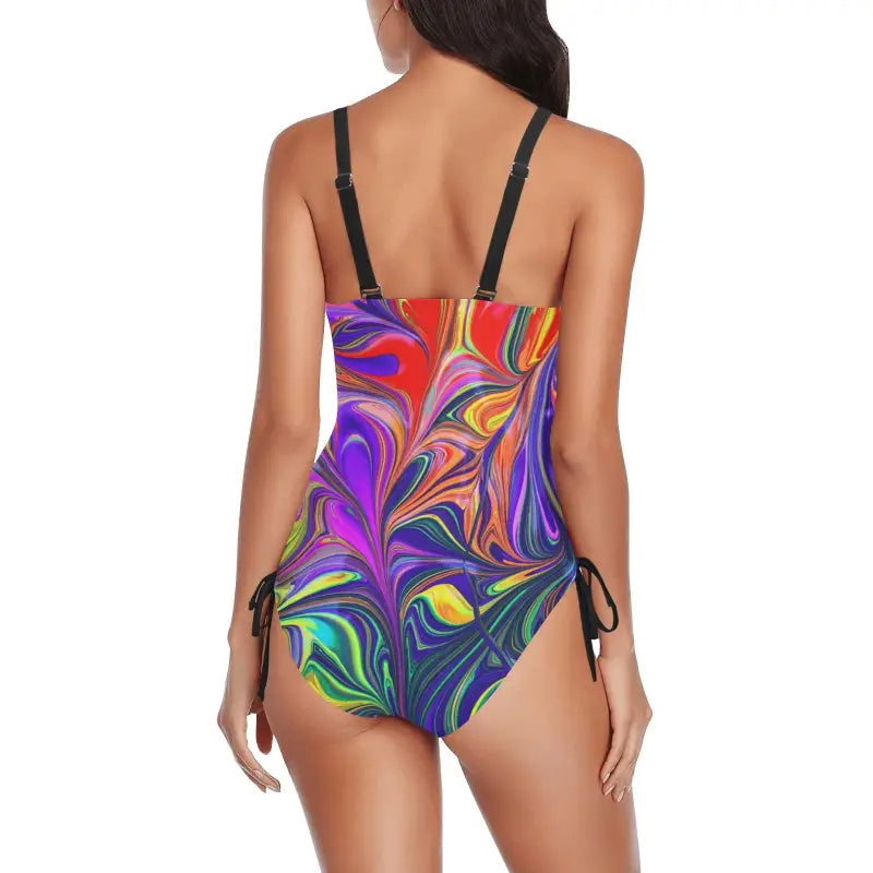 Colorful one-piece swimsuit with a vibrant swirl drawstring pattern on a model from behind