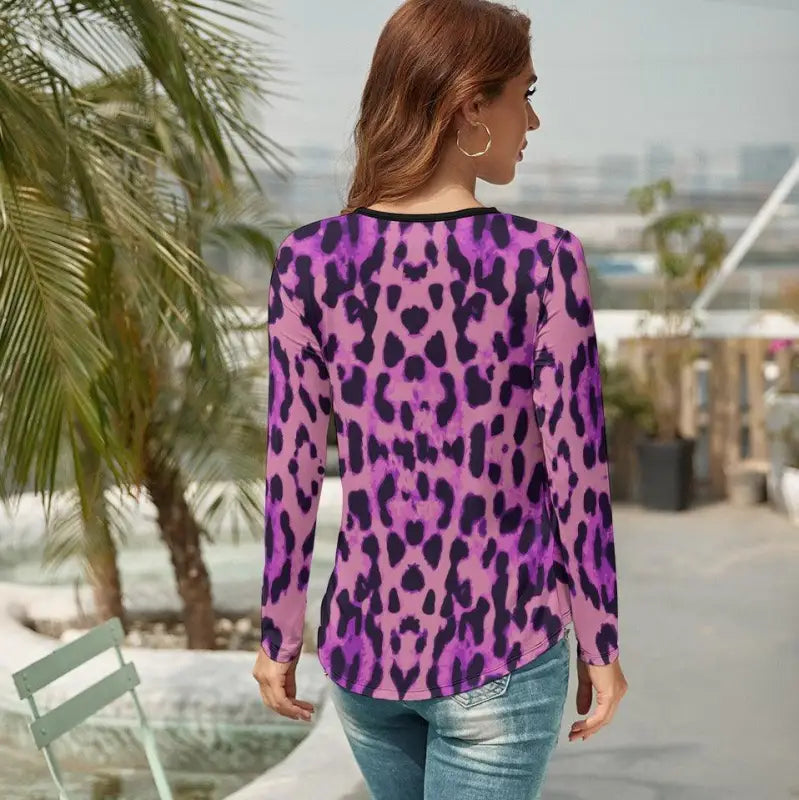 Woman rocking a v-neck long sleeve purple leopard print top with pink and black accents