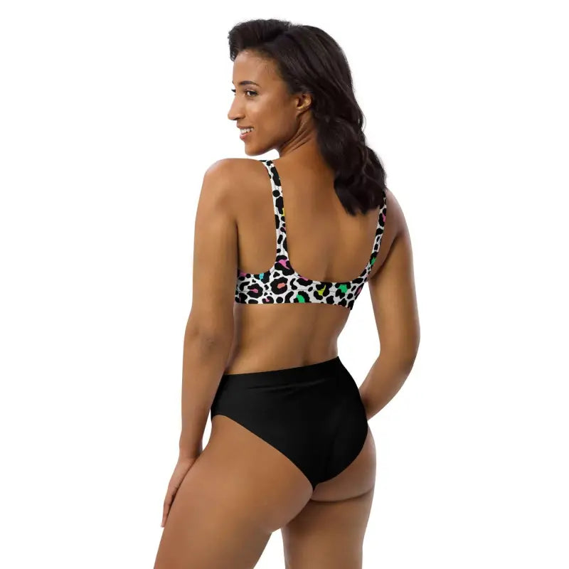 Woman rocking a colorful leopard print bikini set with high-waisted bottoms