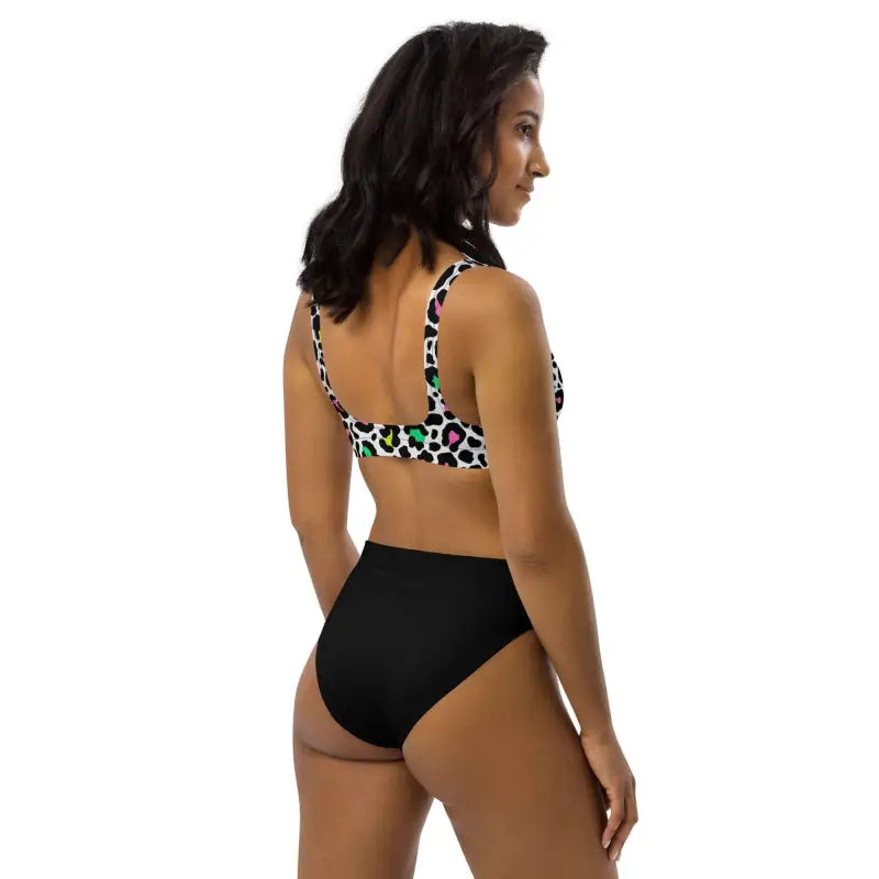 Woman showing off a colorful leopard print high-waisted bikini set from behind