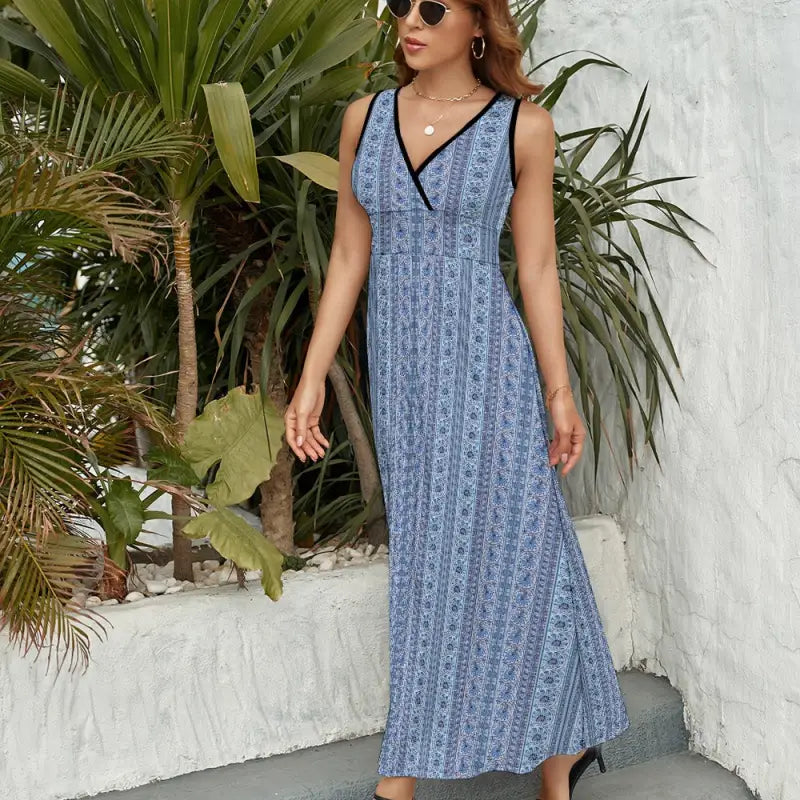 Blue stripe sleeveless maxi dress featuring a V-neckline and bold pattern