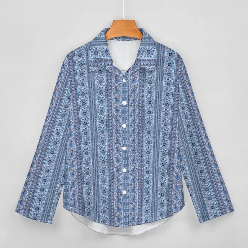 Blue striped long sleeve shirt hanging on a wooden hanger for women’s fashion