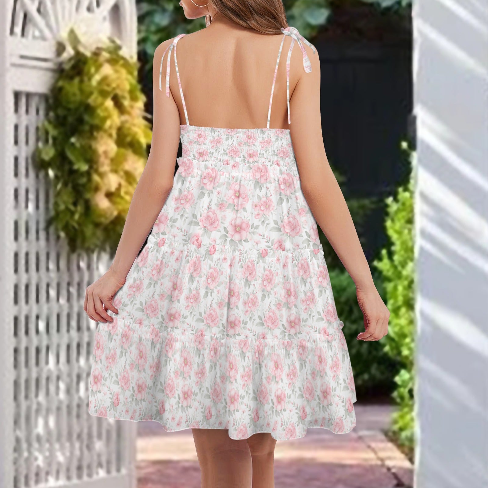 Back view floral mini dress with adjustable tie straps, gathered bodice, and ruffle hem
