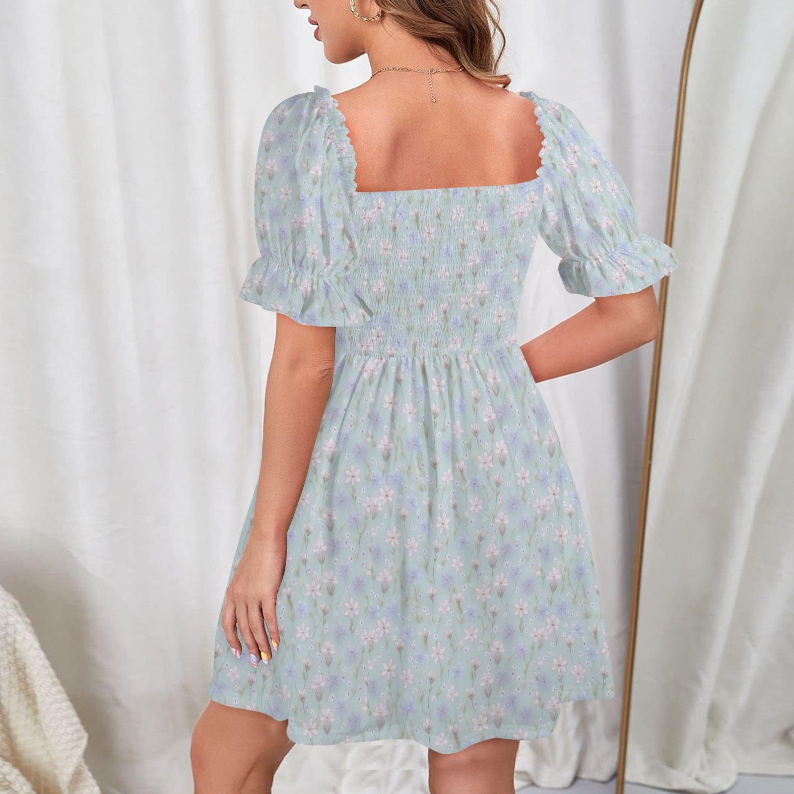 Back view of blue floral dress with shirred bodice and balanced fit