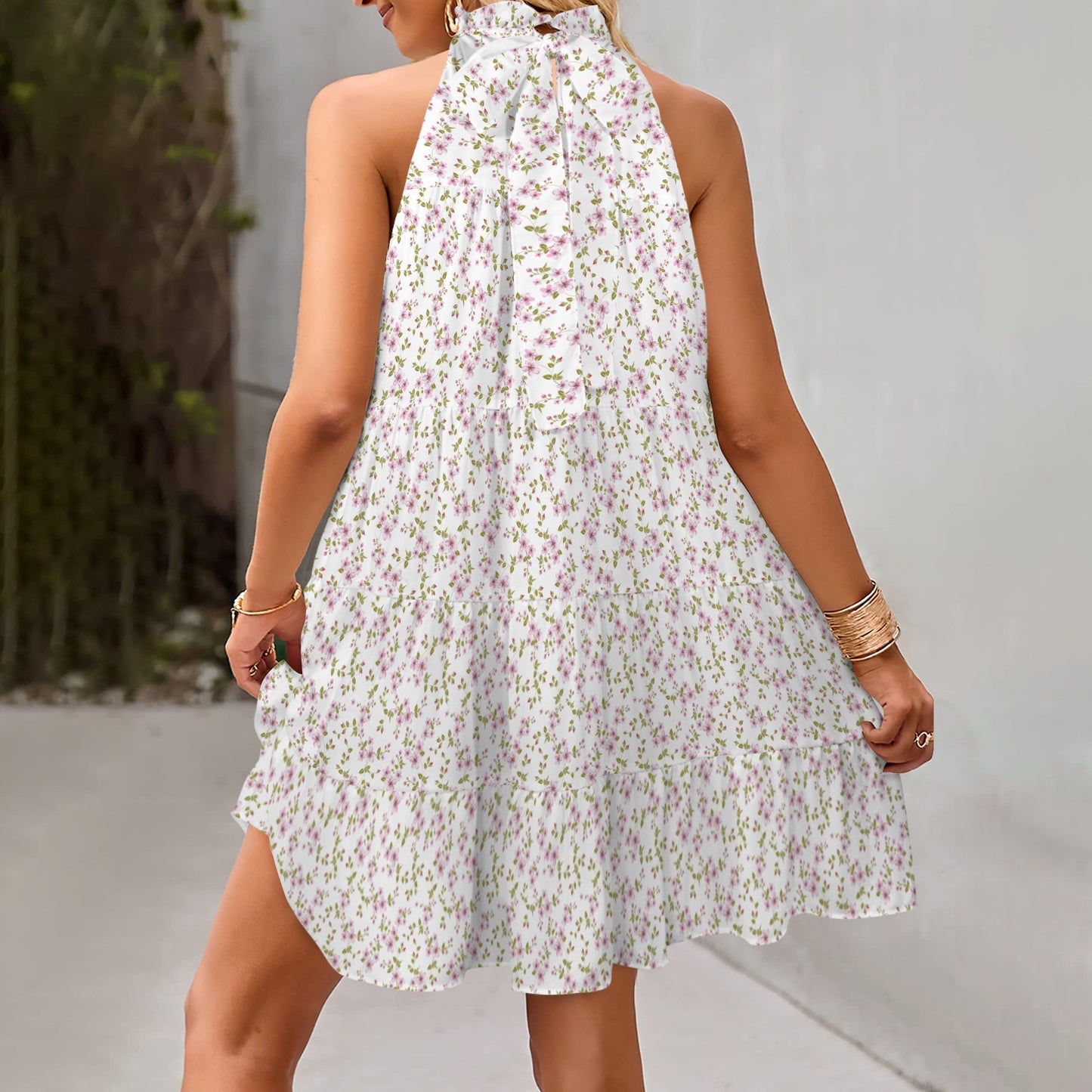 Back view of floral halter dress with tiered skirt and airy structure