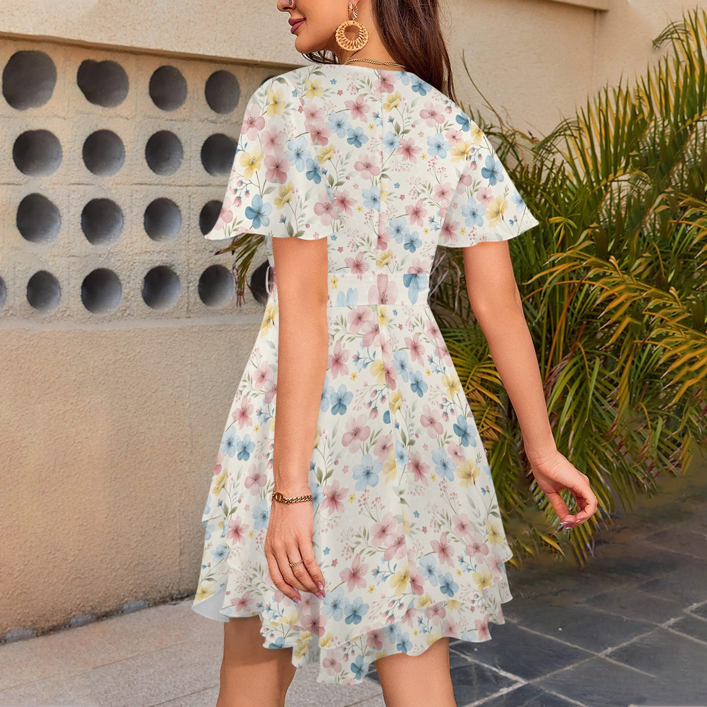 Back view of floral mini dress with short sleeves and flowing hem