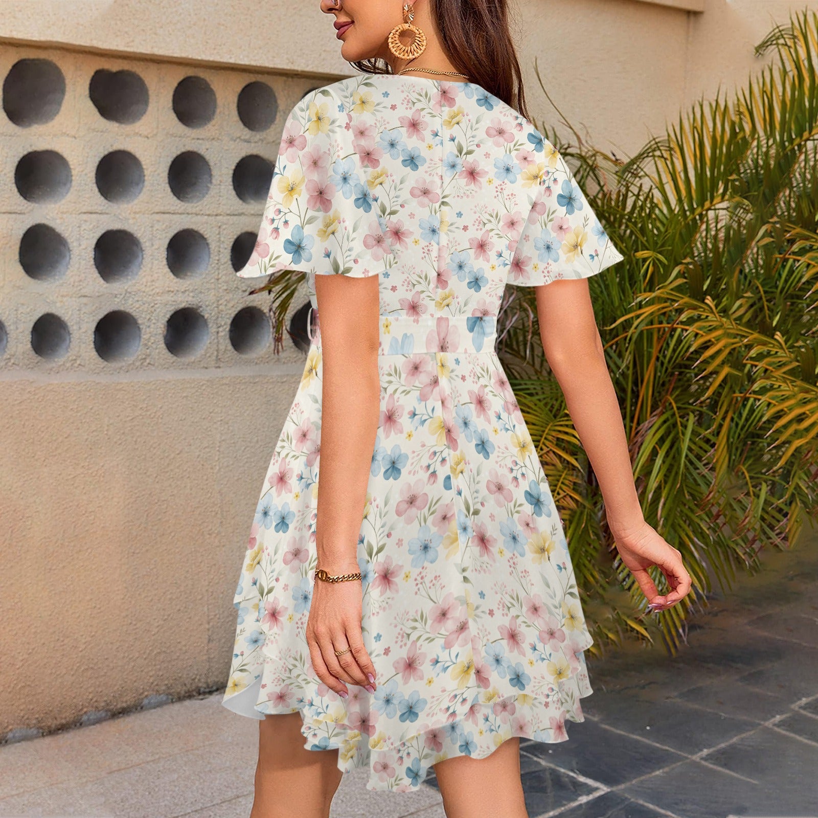 Back view of floral mini dress with short sleeves and flowing hem