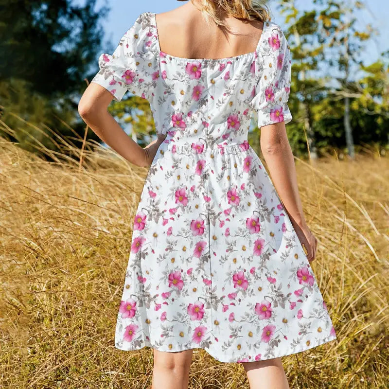 Back view of floral puff sleeve midi dress with square back neckline and flowy A-line skirt