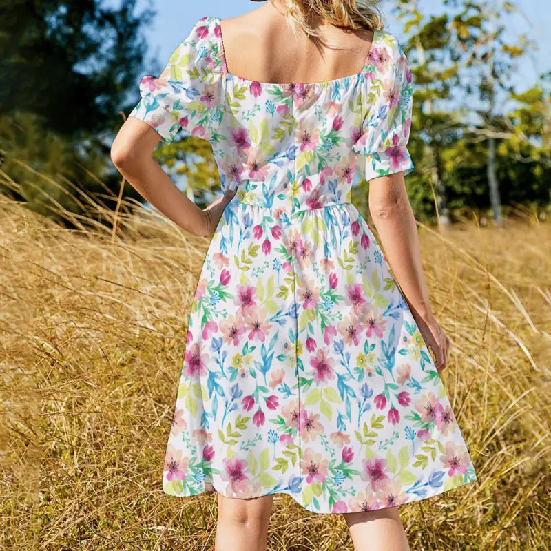 Back view of size-inclusive floral midi dress with puff sleeves