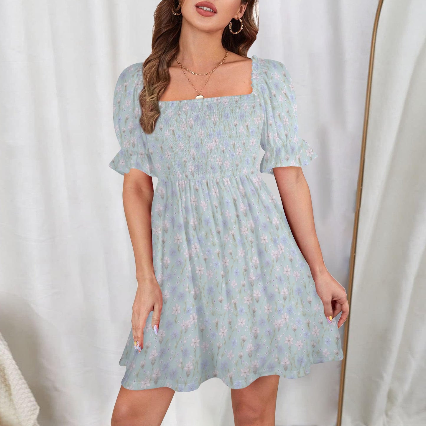 Blue floral mini dress with square neckline and shirred bodice front view studio 