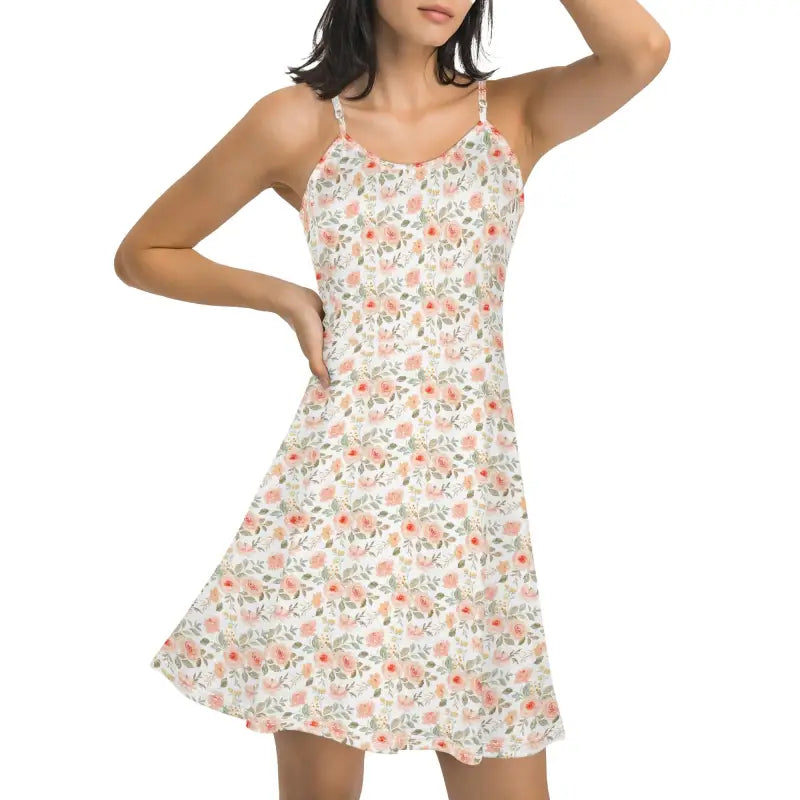 Front view of women’s floral spaghetti strap mini dress with soft pink and peach rose print and A-line silhouette