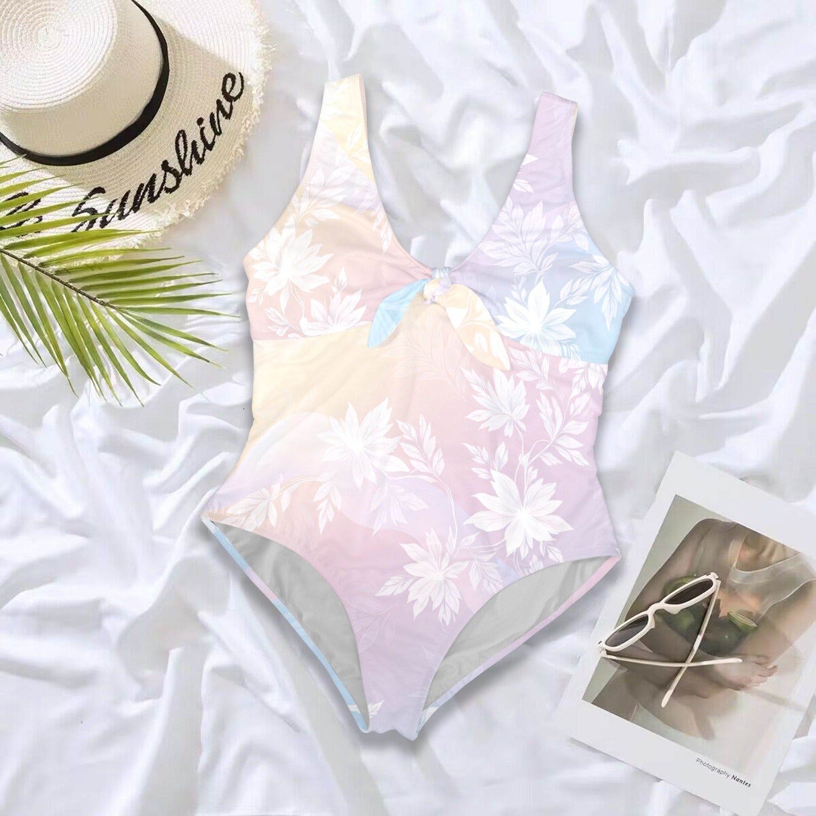 Pastel floral one piece swimsuit flat lay with accessories