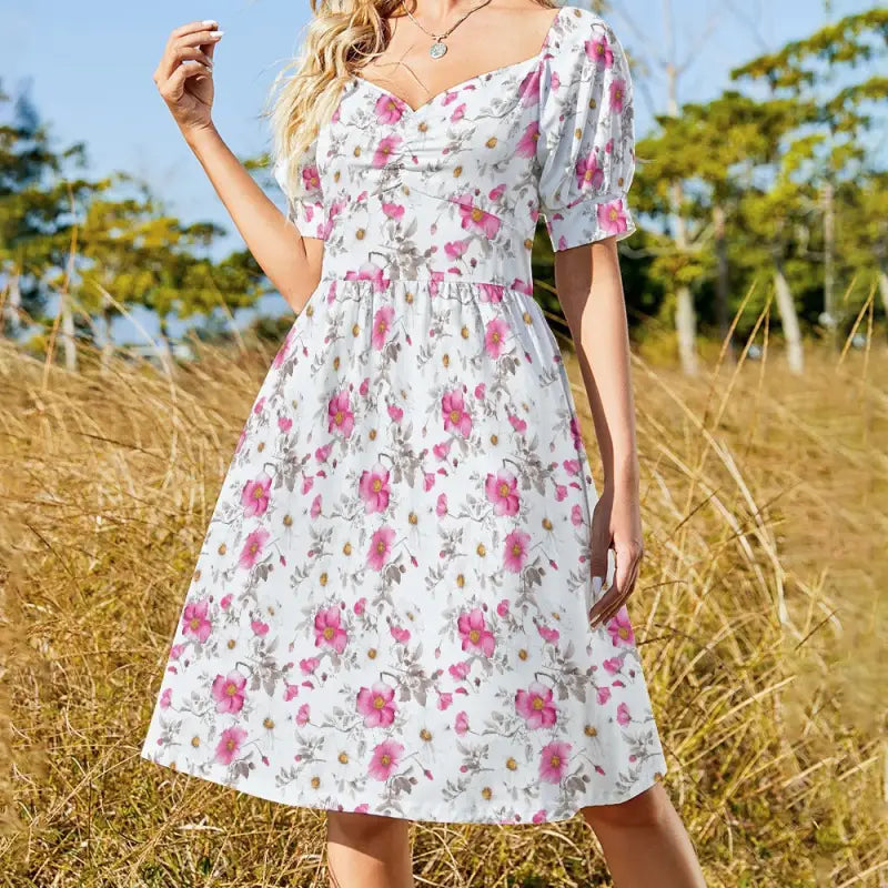 Vintage inspired pink floral puff sleeve dress with sweetheart neckline and cinched waist detail