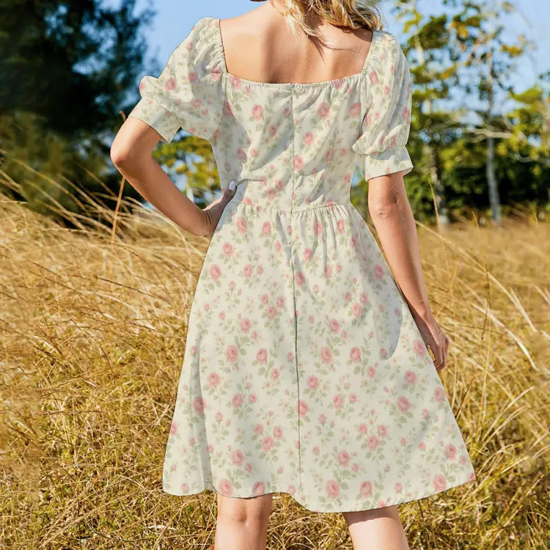 Back of a woman in a boho basic style dress with floral print and puffed sleeves