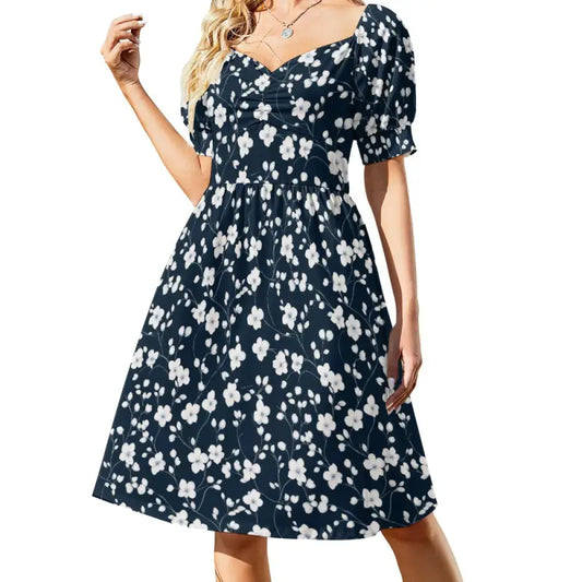 Navy blue floral sweetheart dress with short puffed sleeves and knee-length skirt