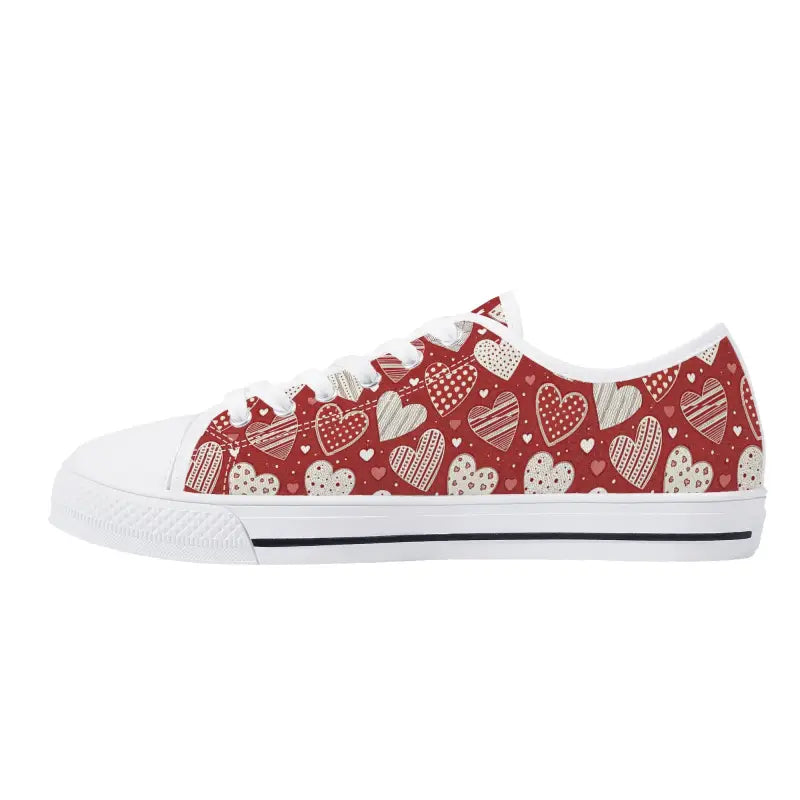 Red women’s low Valentine sneakers with white heart pattern and rubber sole