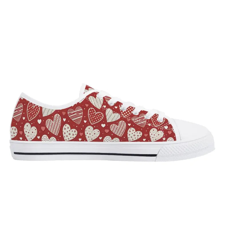 Red women’s low Valentine sneakers with cute white heart pattern and rubber toe cap