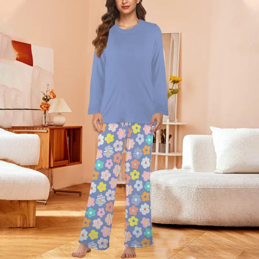 Woman in a blue sweater and fun floral long sleeve pajamas with a chest pocket