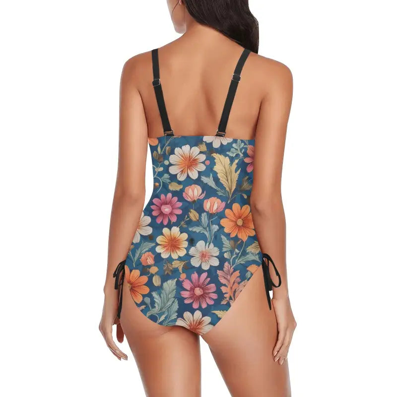 Floral ruched one-piece swimsuit featuring black straps and side ties for a fun beach vibe