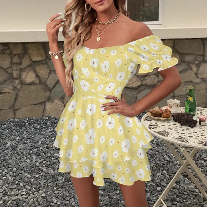 Cute yellow floral off-shoulder romper with ruffled tiers and puff sleeves for boho vibes