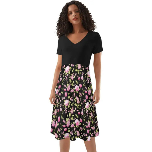 Woman in a black top and floral swing dress showcasing fun floral prints