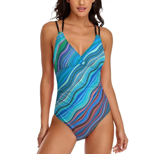 Colorful women’s blue geometric one-piece swimsuit with wavy teal and purple patterns