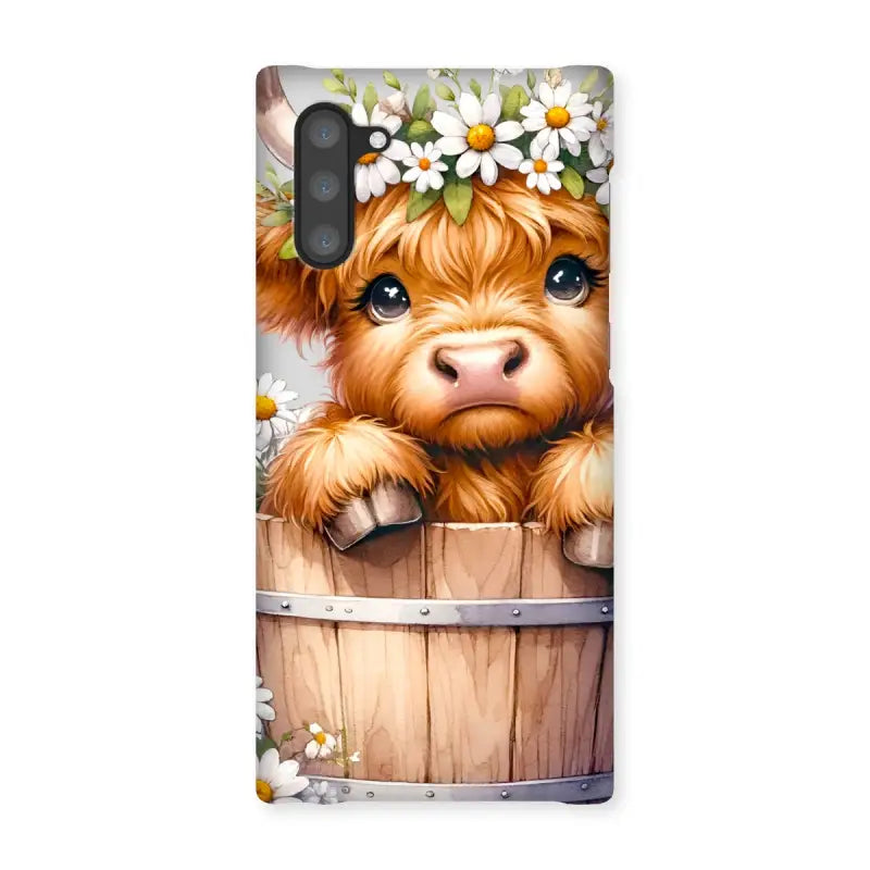 Adorable Highland Cow calf in a barrel with a flower crown for Highland Cow Snap