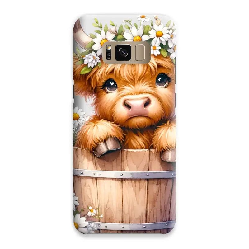 Adorable Highland Cow calf with a daisy crown peeking from a barrel on a snap phone case