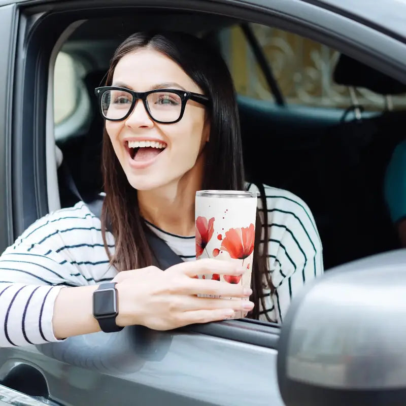 Smiling woman in a car enjoying a fruity drink from her floral personalized 20oz tumbler