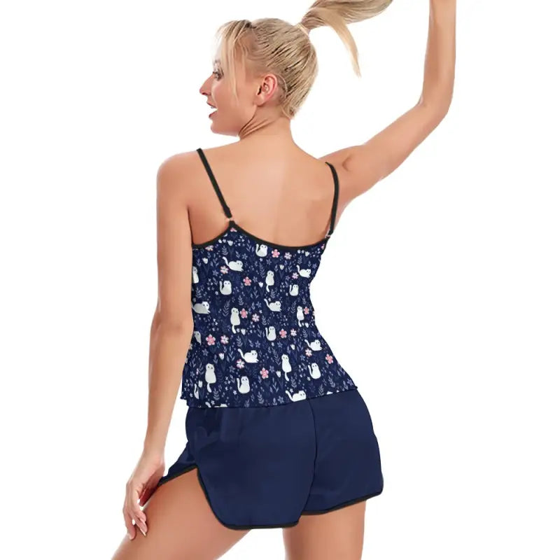 Woman in navy blue patterned tank top and shorts from Ladies Cami Cat Two-Piece Pajama Set