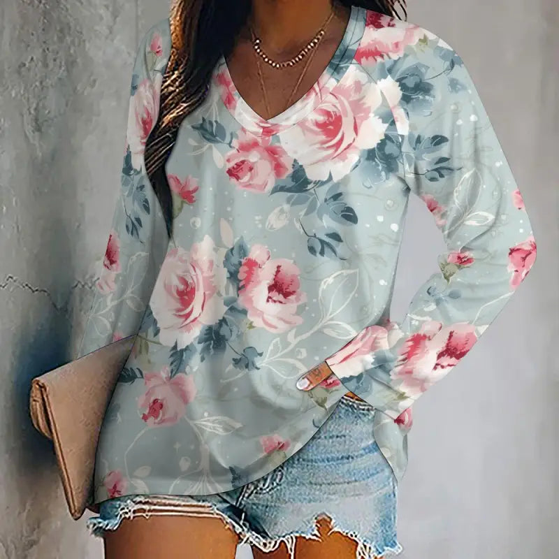 Light blue long-sleeved t-shirt with v-neck design, pink roses, green leaves