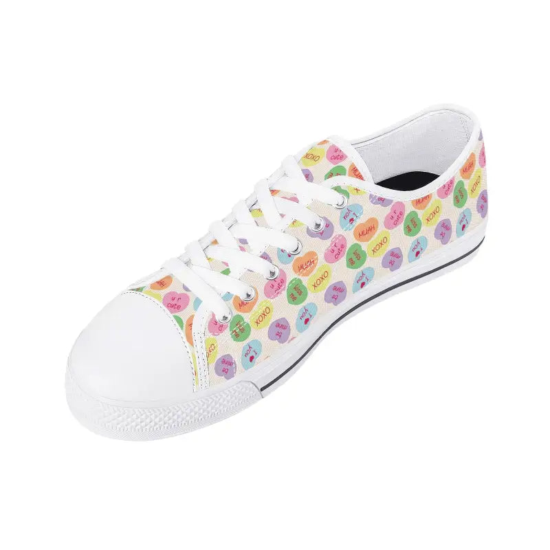 White canvas womens low sneakers featuring a fun candy hearts pattern