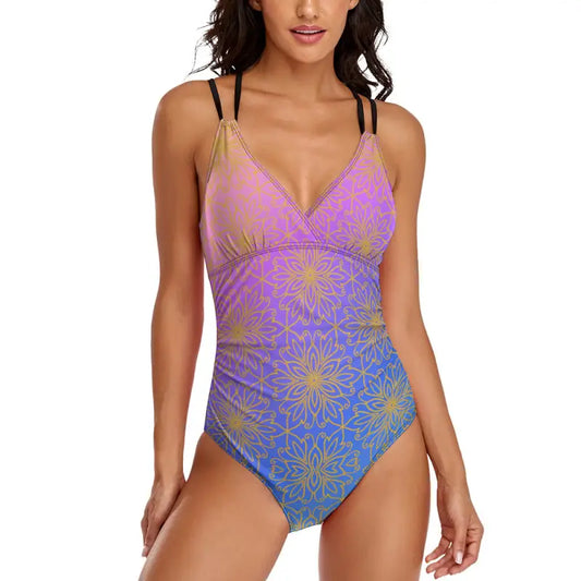 One-piece swimsuit with pink-to-blue gradient and gold mandala, featuring criss cross straps