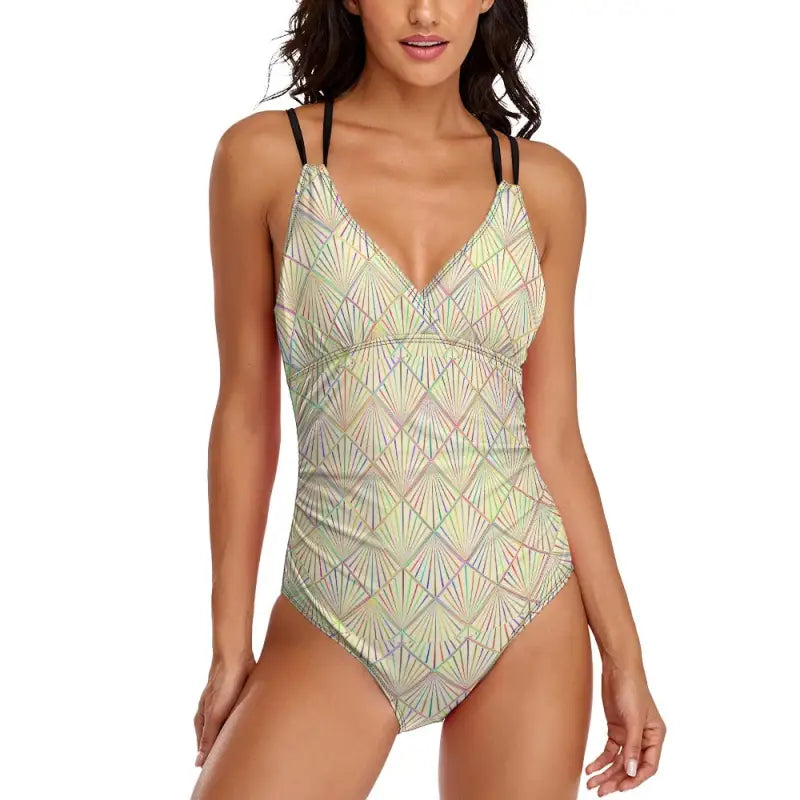 One-piece swimsuit in pale green and beige with black straps, perfect for summer fun