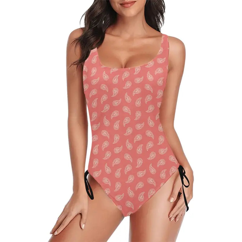 Coral one-piece swimsuit with ruched paisley print and side ties for a boho vibe