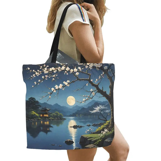 Moon Lake Magic Tote showcasing serene cherry blossoms by a full moon lake canvas