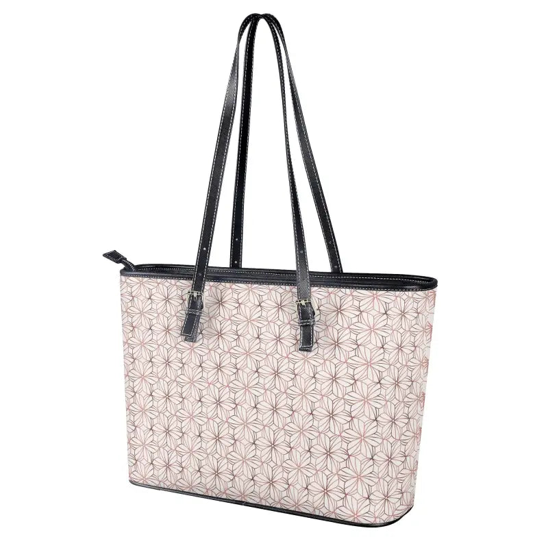 Designer tote bag with geometric pattern, adjustable handles, and zip closure