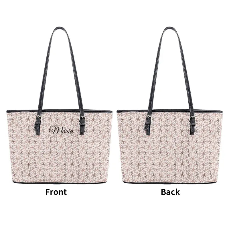 Beige patterned tote bag with black trim, featuring adjustable handles and zip closure