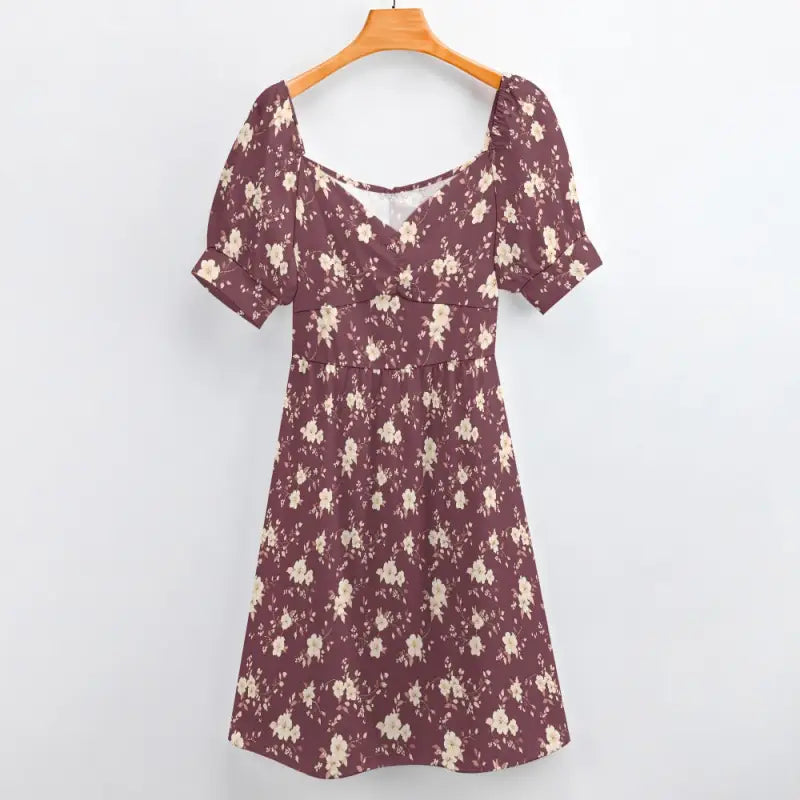 Burgundy floral sweetheart dress with puff sleeves hanging on a wooden hanger