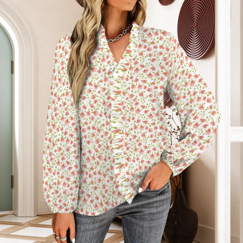 Floral blouse with ruffled placket and long sleeves in vibrant peach floral print